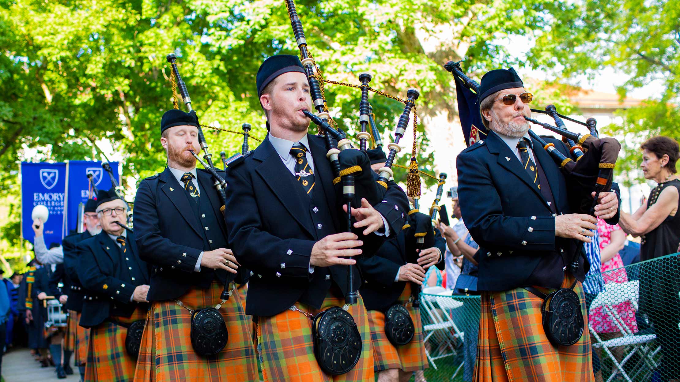 Photo of a procession of bagpipe players at the Commencement ceremony