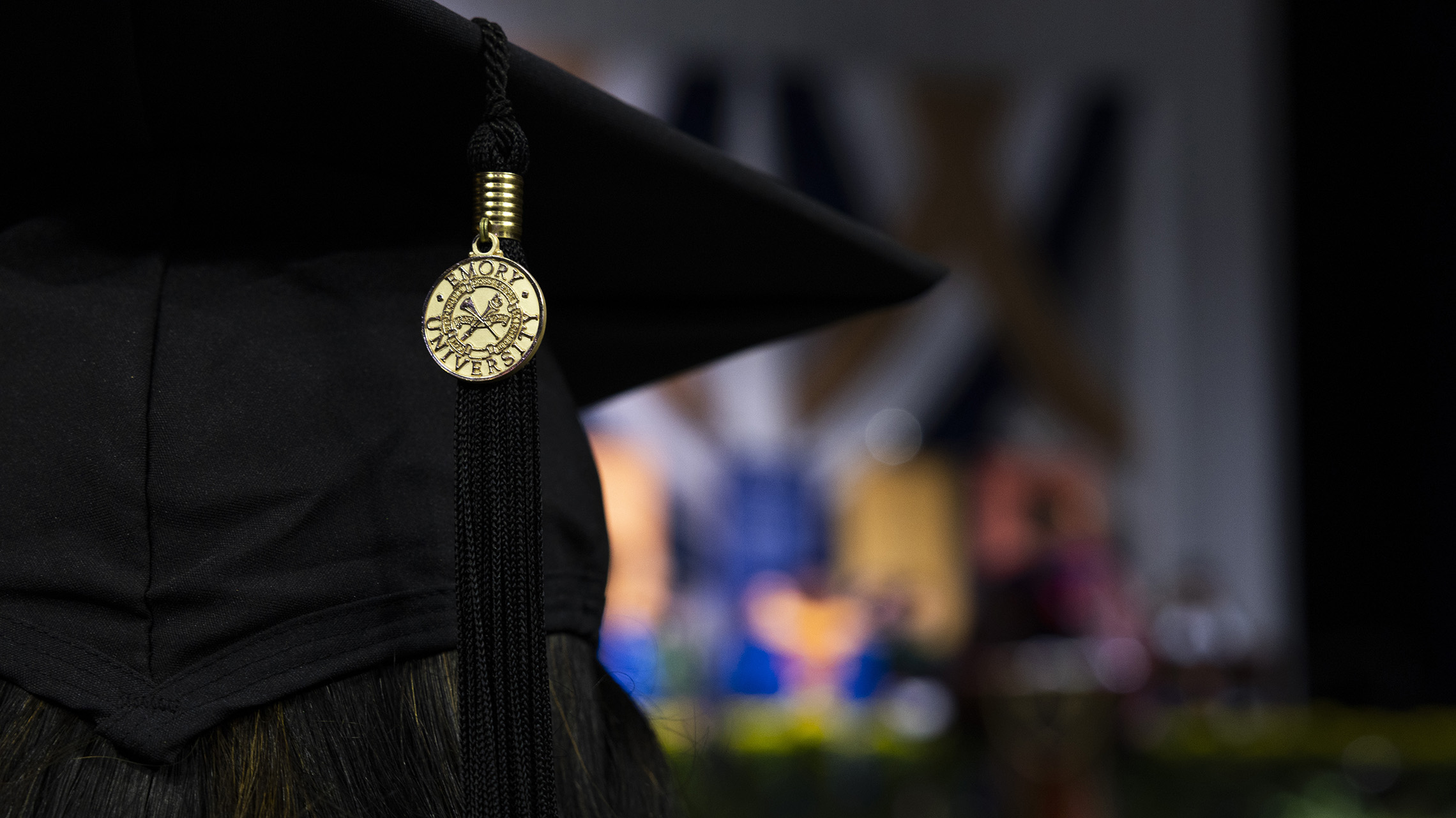 a black graduation cap with an Emory University tassel